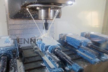 CNC drilling equipment running with a rotating drill and pipes for cutting fluid